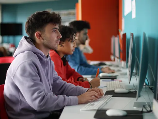 A group of students working on computer during a class in college